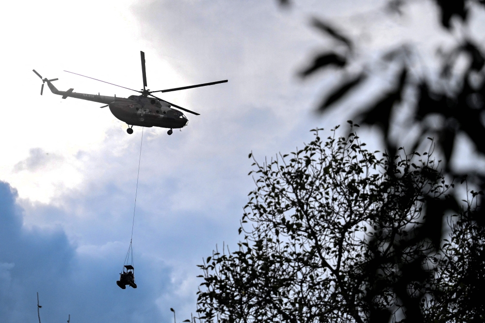 A Nepali Army helicopter transports an excavator during rescue operations in the aftermath of flash floods in Nepal’s Nuwakot district August 31, 2026. — AFP pic