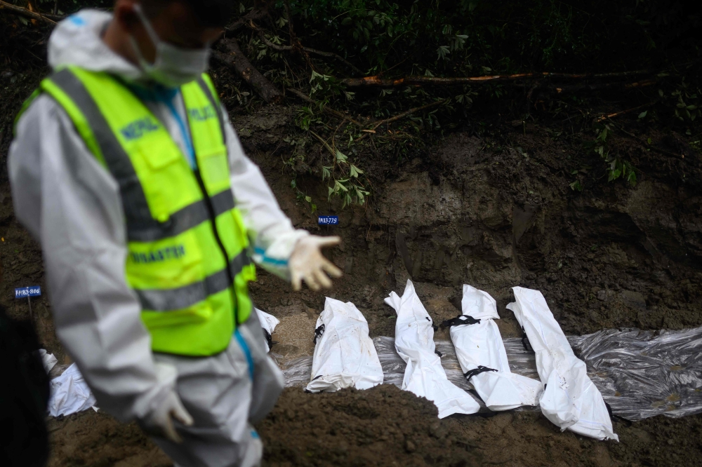 Unidentified flood victims lie in a mass burial pit at Gokarna forest reserve in Kathmandu on September 1, 2026, as Nepal’s death toll surpassed 1,000. — AFP pic