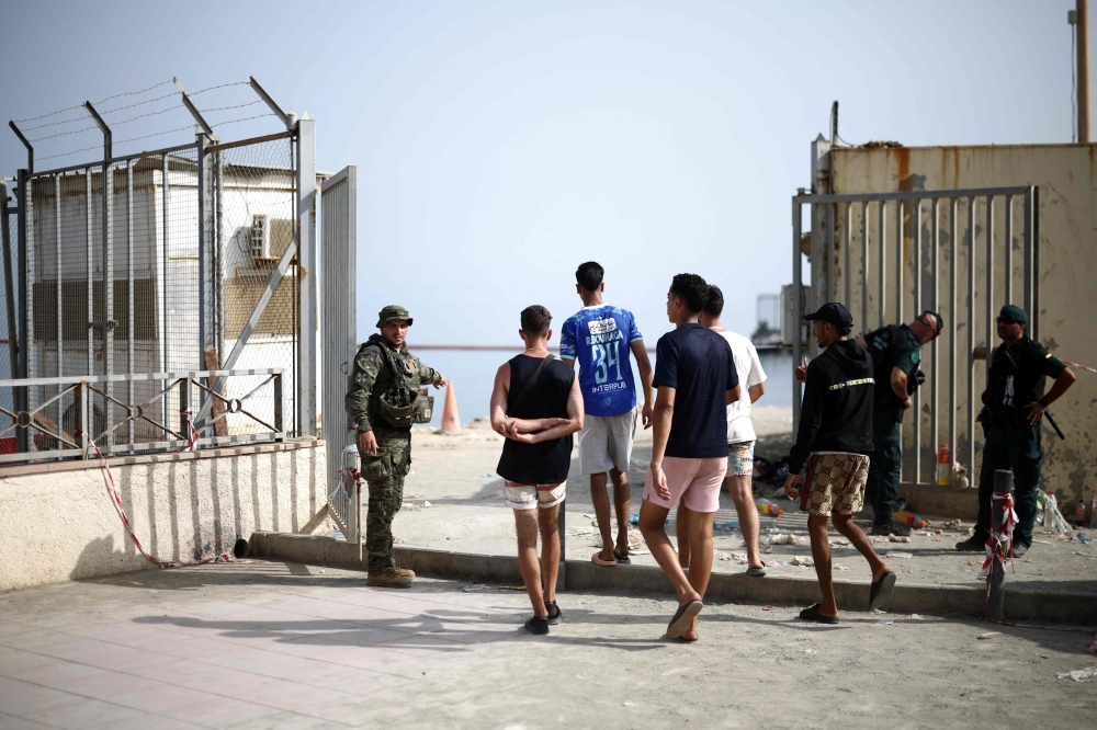 Migrants approach the Ceuta-Morocco border gate in the Spanish North African enclave of Ceuta August 1, 2026. — AFP pic 