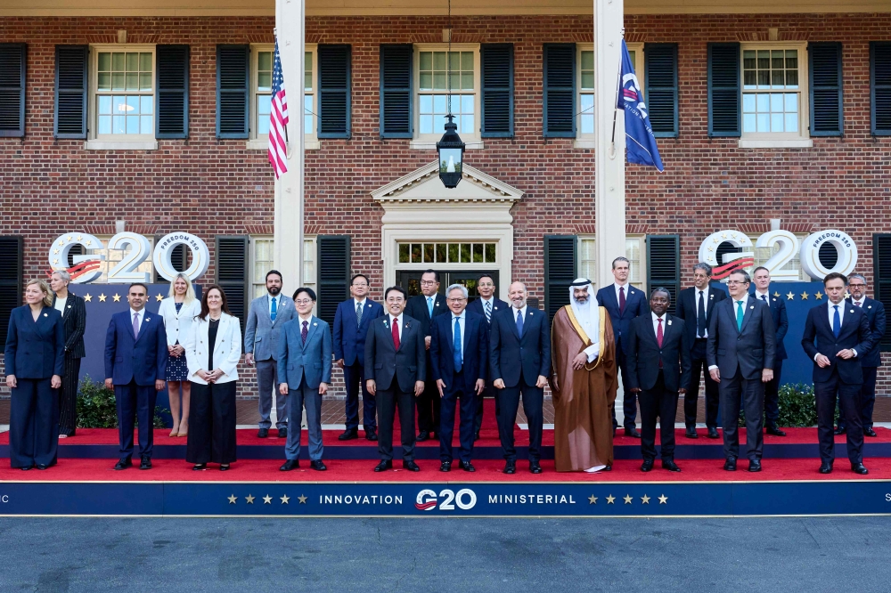 Nvidia CEO Jensen Huang (centre) flanked by Japan’s Minister of Economy Ryosei Akazawa (left) and US Secretary of Commerce Howard Lutnick (right), stands with members of the G20 Innovation Ministerial summit as they pose for a group photo outside the Carolina Inn in Chapel Hill, NC September 2, 2026. — AFP pic