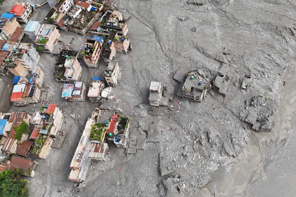 An aerial view shows houses damaged and deluged in sludge in the aftermath of flash floods at Trishuli Center in Nepal’s Nuwakot district September 1, 2026. — AFP pic