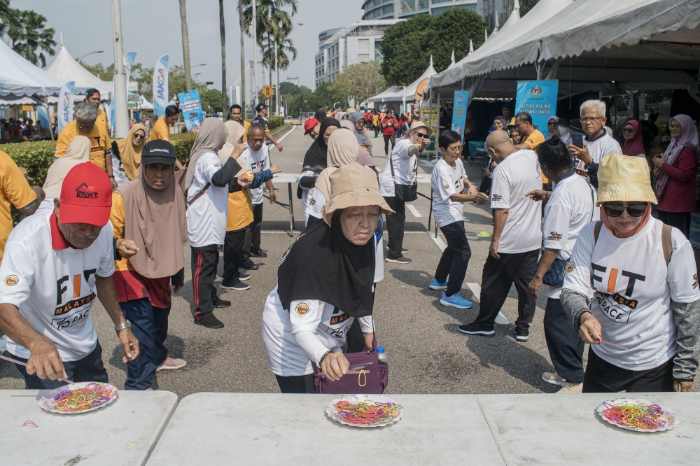 People take part in an activity during the National Sports Day 2023 celebration at Dataran Putrajaya in Putrajaya on October 14, 2023. — Picture by Shafwan Zaidon