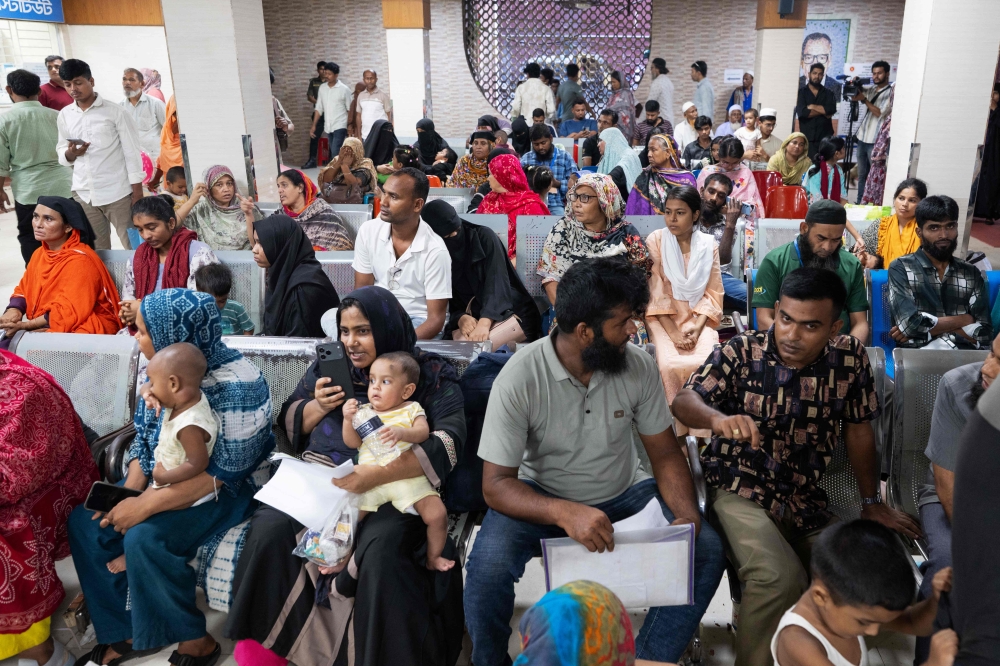 Parents wait with their children for measles treatment at Bangladesh Shishu Hospital & Institute in Dhaka on September 3, 2026, amid a surge in cases that has overwhelmed paediatric wards. — AFP pic