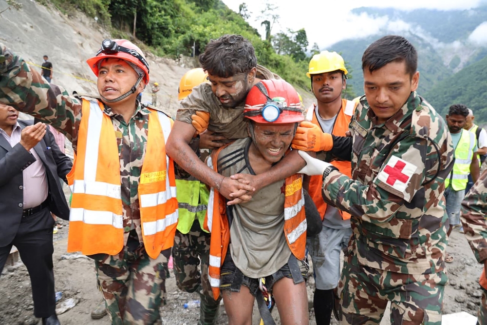 Nepali soldiers carry one of two rescued hydropower workers from a debris-filled tunnel at the Trishuli-3A Hydropower Project in Rasuwa district on September 4, 2026, more than a week after the catastrophic flood that has been hailed a ‘miracle’. — Nepal Army handout pic via AFP