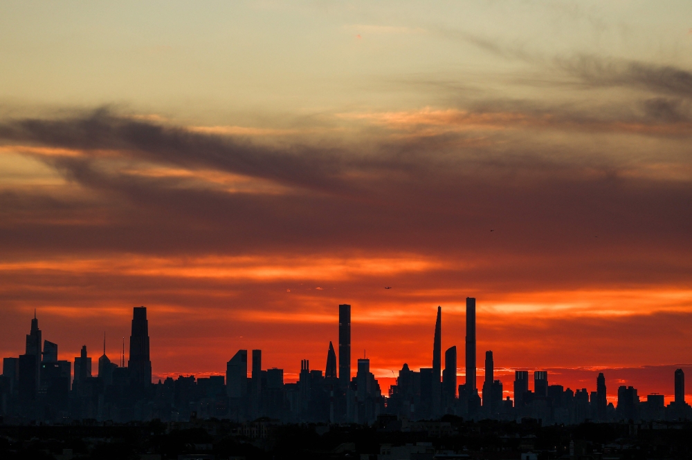 A general view of the Manhattan skyline during sunset. After the initial dust cloud that followed the collapse of the World Trade Centre, months of pollution and lingering dust ensued, causing cancers that thousands of New Yorkers still suffer today. — Julian Finney/Getty Images North America/Getty Images pic via AFP