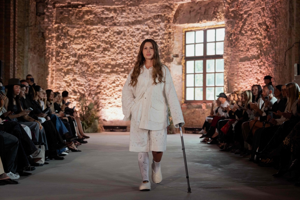 A model walks down the runway in designer Igor Sidletskiy’s latest inclusive fashion line. — AFP pic