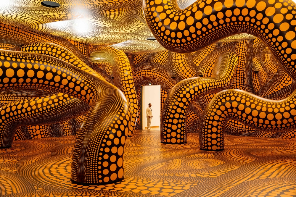 A man looks at the installation ‘Infinity Mirrored Room – The Hope of the Polka Dots Buried in Infinity Will Eternally Cover the Universe’ during a press preview of the exhibition dedicated to Japanese artist Yayoi Kusama (1929-2026) at Stedelijk Museum in Amsterdam September 9, 2026. — AFP pic