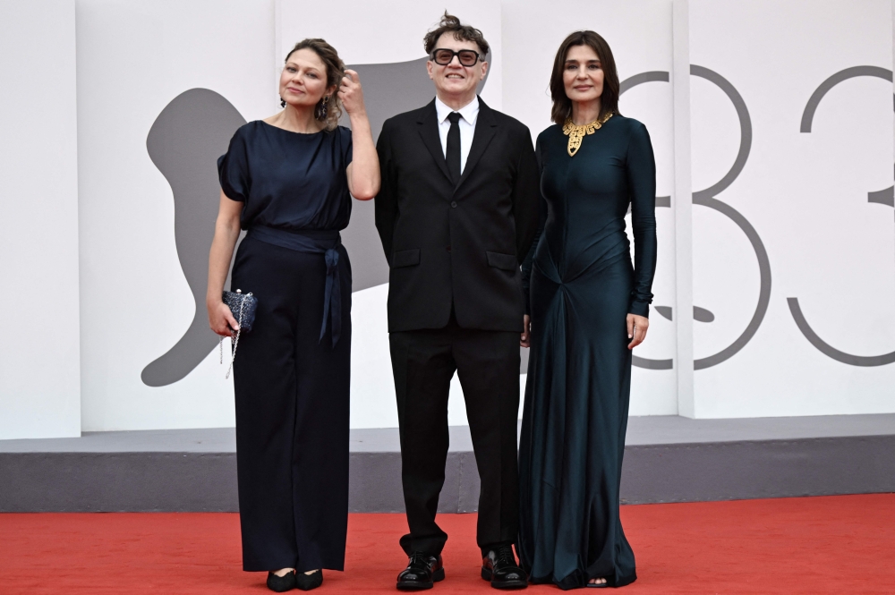 (From left) Radmila Shchogolieva, Director Ilya Khrzhanovsky and Maria Nafpliotou attend the red carpet event for the screening of ‘Dau’ presented in competition at the 83rd International Venice Film Festival, at Venice Lido September 9, 2026. — AFP pic