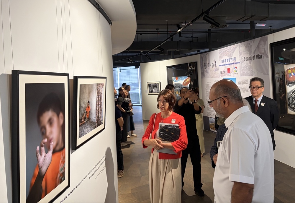 Digital minister Gobind Singh Deo and the director of the International Campaign to Ban Landmines–Cluster Munition Coalition (ICBL-CMC) Tamar Gabelnick (left) at the Scars of War exhibition. — Picture by Opalyn Mok