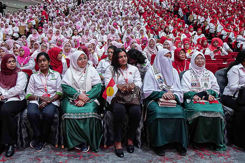 PAS Muslimat delegates dressed in green sit in the front row among Umno members during the joint opening of the party’s Women, Youth and Puteri wing assemblies at the World Trade Centre in Kuala Lumpur, September 9, 2026. — Picture by Yusof Isa