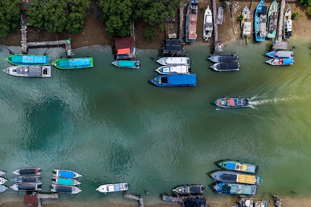 A fishing boat returns after a day at sea, reflecting fishing’s role as a key source of income and economic activity for the local community in Mersing. — Bernama pic