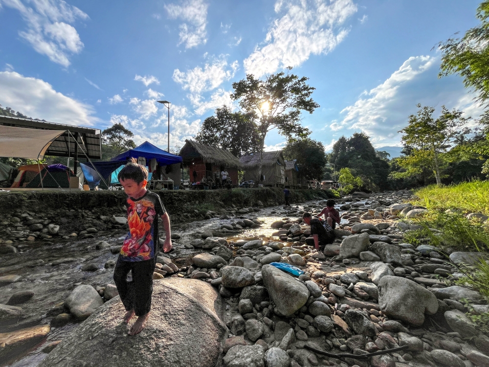 Children play freely in the shallow, rocky river at Dakoh, Pos Balar, an Orang Asli ecotourism destination.  — Bernama pic