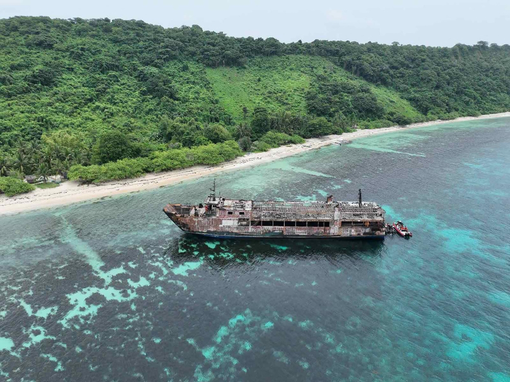 An aerial view of the ill-fated Philippine ferry M/V June Aster with coast guard boats at the stern off the shores of Coron in Palawan province, on September 11, 2026. — Philippine Coast Guard handout pic via AFP