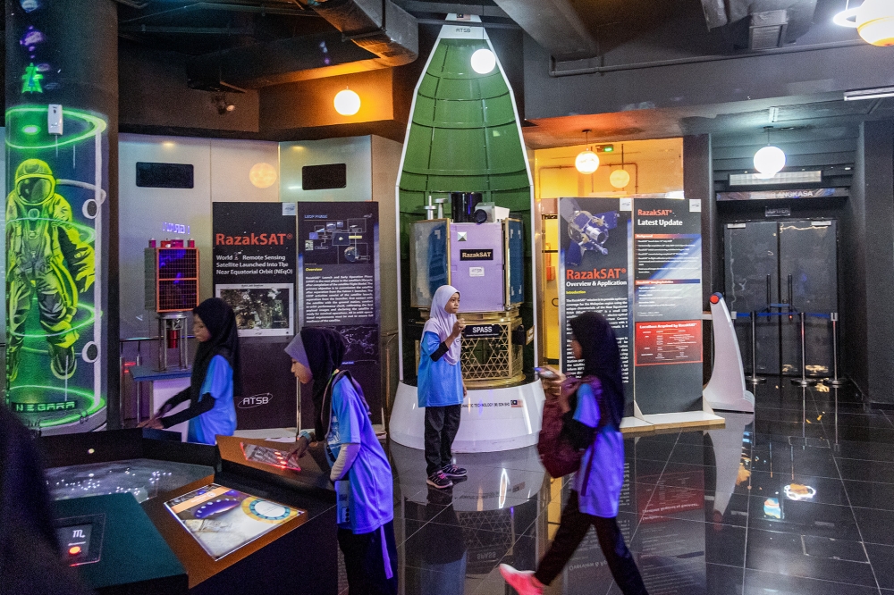 School students explore the interactive exhibits at Planetarium Negara. — Picture by Firdaus Latif