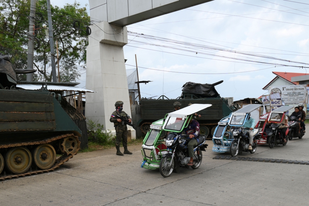 Motorists drive past an army checkpoint with two M113 armored personnel carriers (APC) in Marawi City, Lanao del sur province, on the southern Philippines island of Mindanao on September 13, 2026. — AFP pic