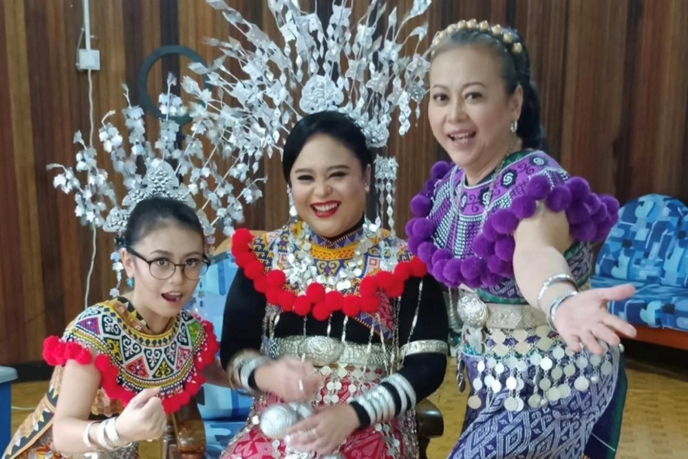 (From right) Judy with her daughters, Charraine and Pheonnie, during the Gawai Dayak celebration at the longhouse. — The Borneo Post pic 