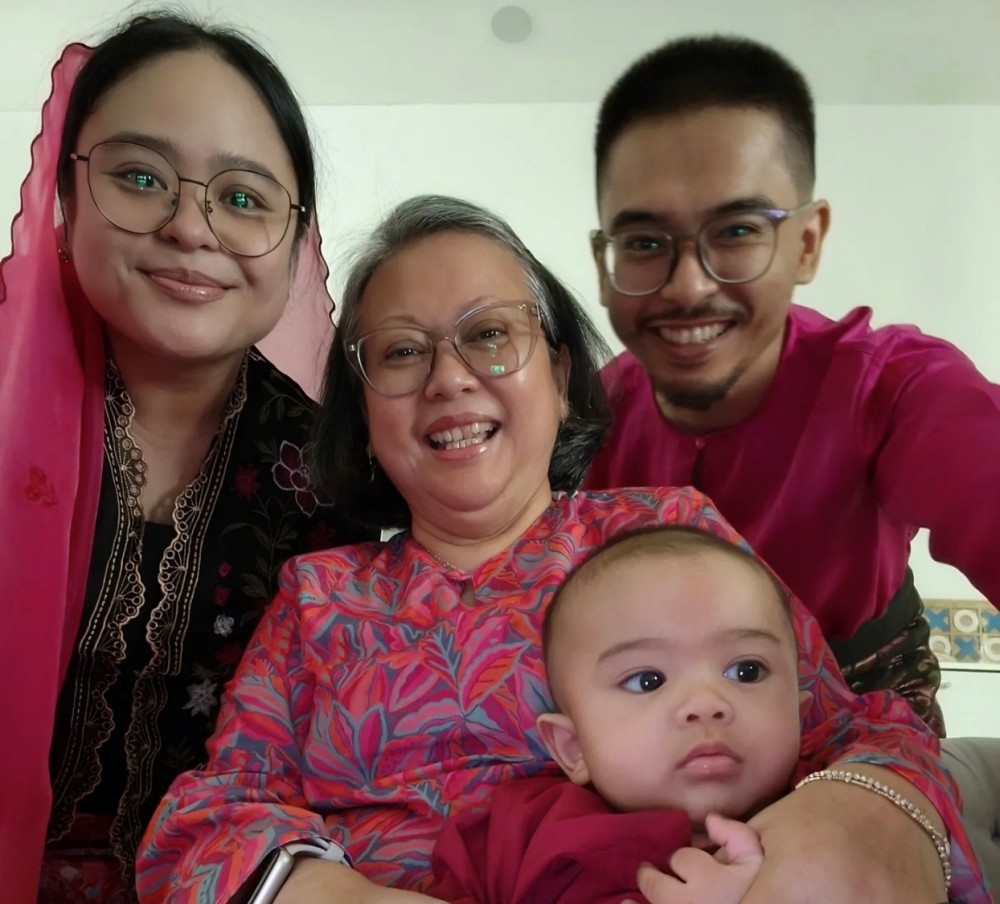 Judy holds her grandchild Elijah Yusuf, the son of her daughter Charraine and Mohd Yusri Mohd Yarabi. — The Borneo Post pic 