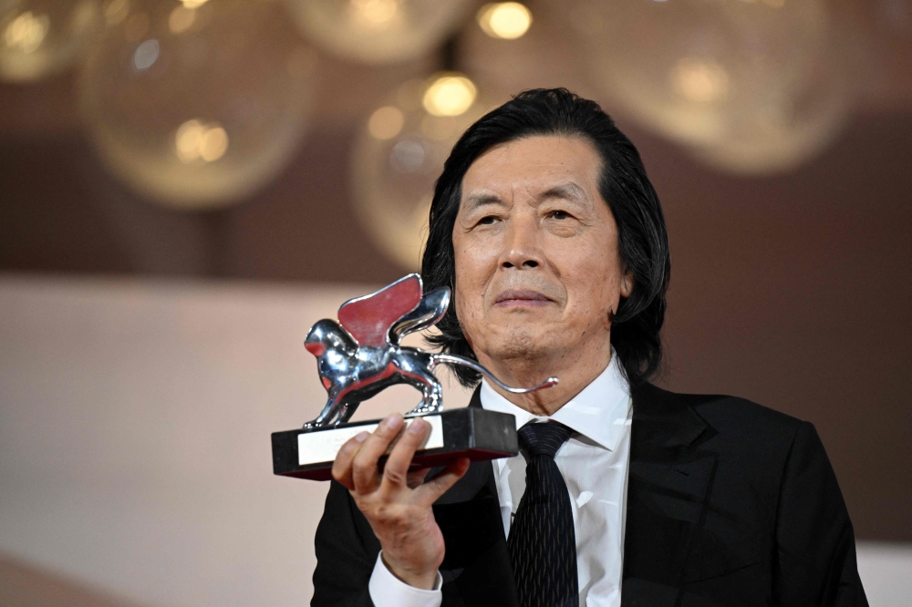 South Korean director Lee Chang-dong receives the Silver Lion, the Grand Jury Prize for ‘Possible Love’ (‘Ga-neung-han sa-rang’ ) at the closing ceremony of the 63rd Venice Film Festival at Venice Lido on September 12, 2026. — AFP pic