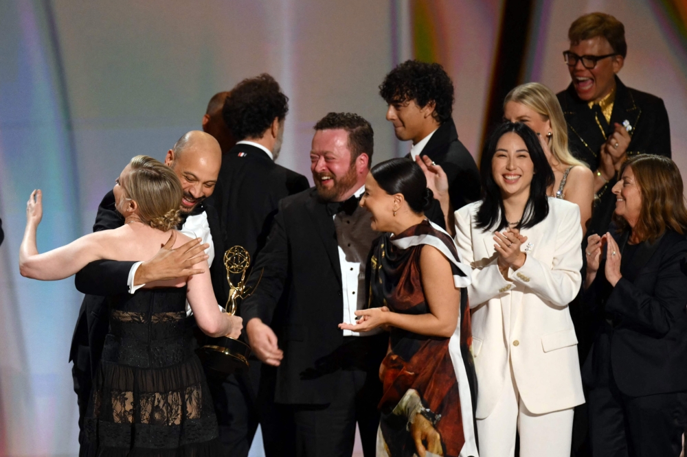 US screenwriter Katie Dippold hugs members of her team as they accept the award for Outstanding Writing for a Comedy Series for ‘Widow’s Bay’ onstage during the 78th Primetime Emmy Awards at the Peacock Theatre at LA Live in Los Angeles on September 14, 2026. — AFP pic 