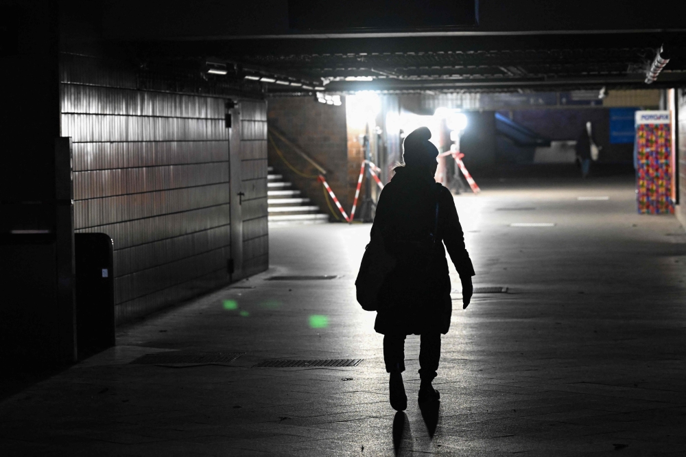 A commuter walks along a passage at the Wannsee S-Bahn train station which is out of service on January 4, 2026. — AFP pic