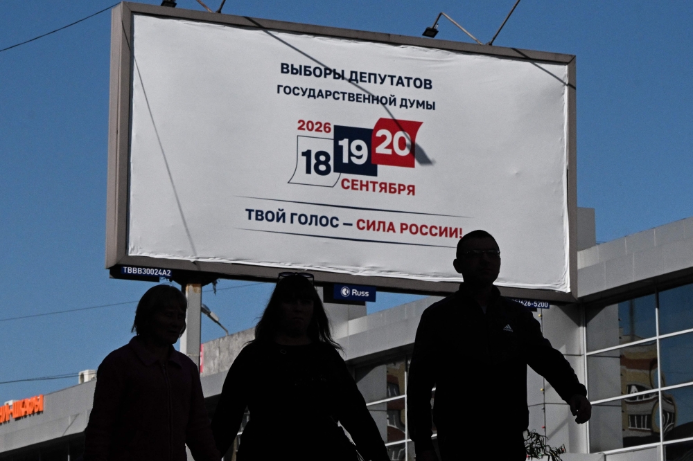 Pedestrians walk past a billboard announcing the upcoming election for Russia’s lower house of parliament, the State Duma, in Tambov, Russia September 10, 2026. — AFP pic