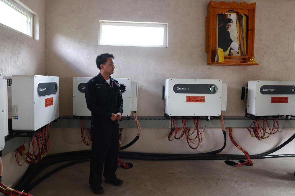 This photograph taken on August 30, 2026 shows senior engineer Rinzin Galley standing next to solar inverters in a control room at the Norion Renewable Energy company compound in Bhutan's capital city of Thimphu. — AFP pic