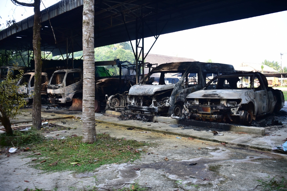 Charred vehicles sit outside a government office in Narathiwat province on August 23, 2026, following dozens of coordinated arson attacks across southern Thailand's insurgency-hit region. — AFP pic
