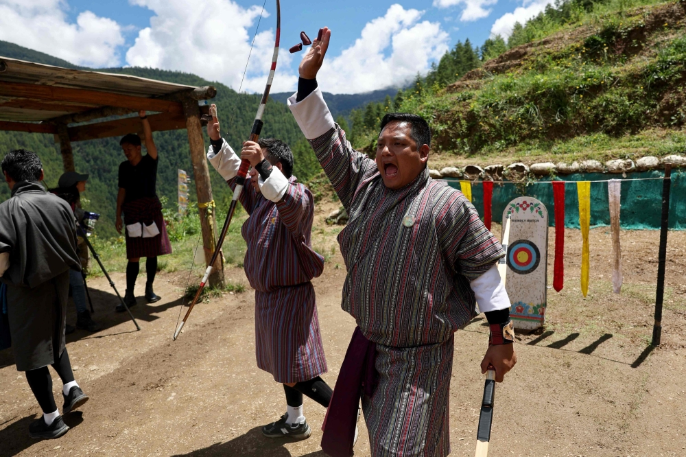 Archers celebrate after hitting the target during a match in Thimphu, Bhutan, on August 29, 2026. Traditional archery, Bhutan’s national sport, is facing shrinking space for ranges amid development and safety concerns. — AFP pic