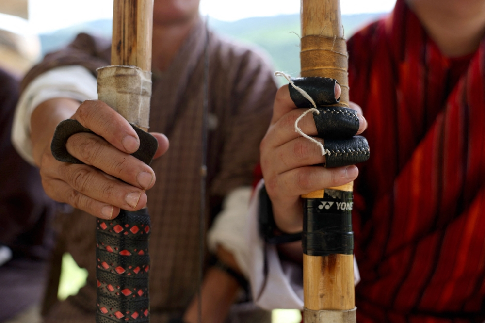 Archers wearing leather finger guards wait for their turn during a match on a mountain in Thimphu, Bhutan on August 29, 2026. Played with a bamboo bow and arrows, the sport evolved from hunting and military traditions and is now a key part of cultural events, as well as a popular weekend activity. Some fans fear for its future as development and safety concerns eat away at space for archery ranges. — AFP pic