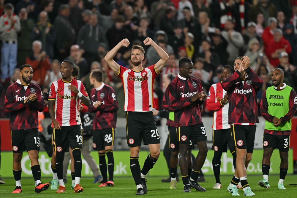Brentford’s players celebrate on the pitch after the English Premier League football match between Brentford and Chelsea at the Gtech Community Stadium in London on September 18, 2026. — AFP pic