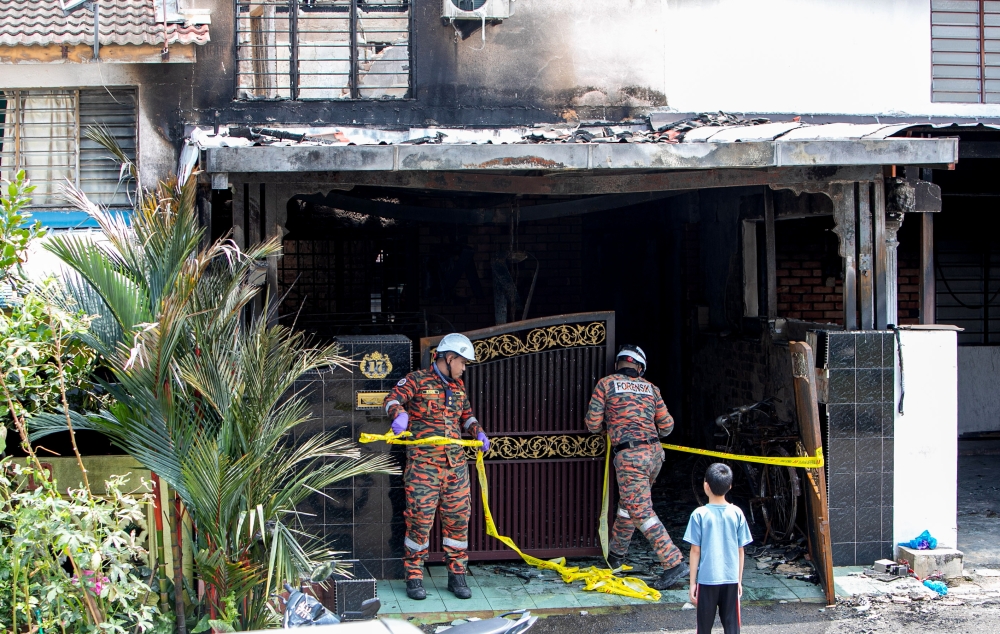 Fire and Rescue Department (JBPM) personnel work at the scene after an elderly couple and their grandson were killed in a fire involving a two‑storey terraced house at Persiaran Desa Tambun 4, Taman Desa Tambun in Ipoh September 20, 2026. — Bernama pic