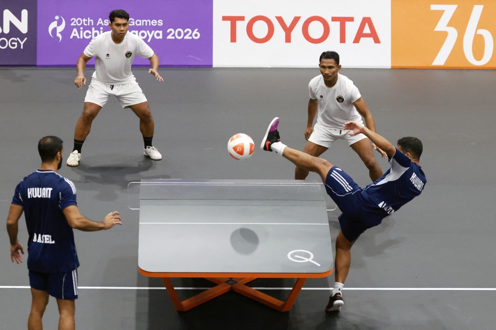Kuwait’s Basel Ahmad and Abdulwahab Alqattan (in blue) play a point against Indonesia’s Husni Uba and La Ode Mardan during their men’s doubles bronze medal teqball match at the 2026 Asian Games in Nagoya on September 20, 2026. — AFP pic