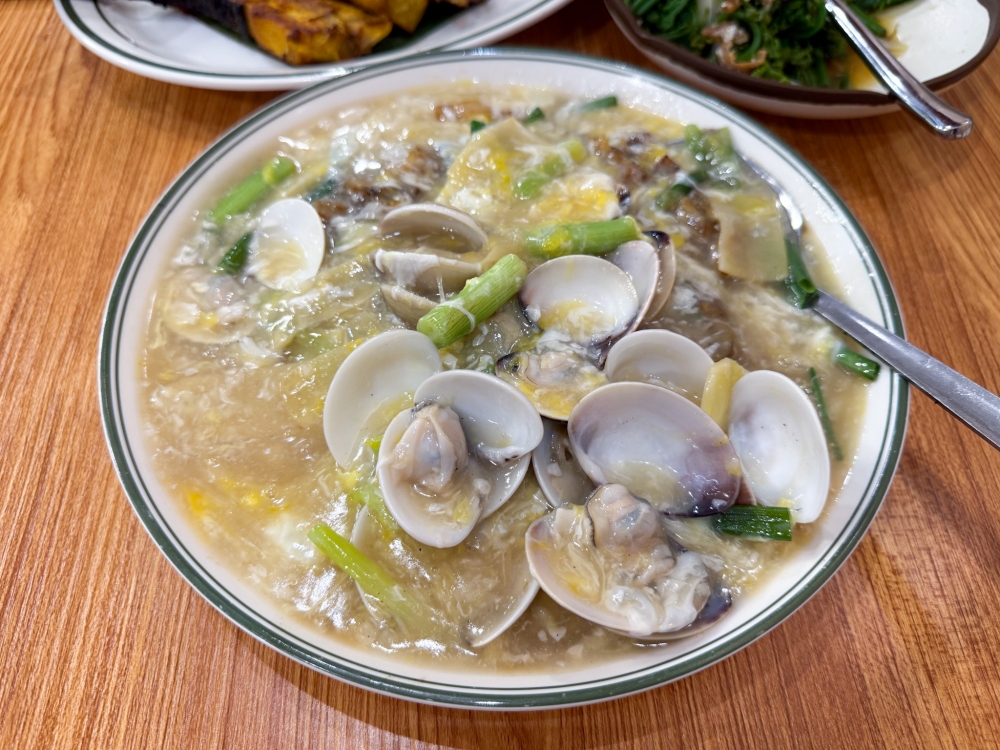 Lala Kuey Teow may have fewer clams, but the hero is the smoky scented noodles slick with the eggy sauce. — Picture by Lee Khang Yi