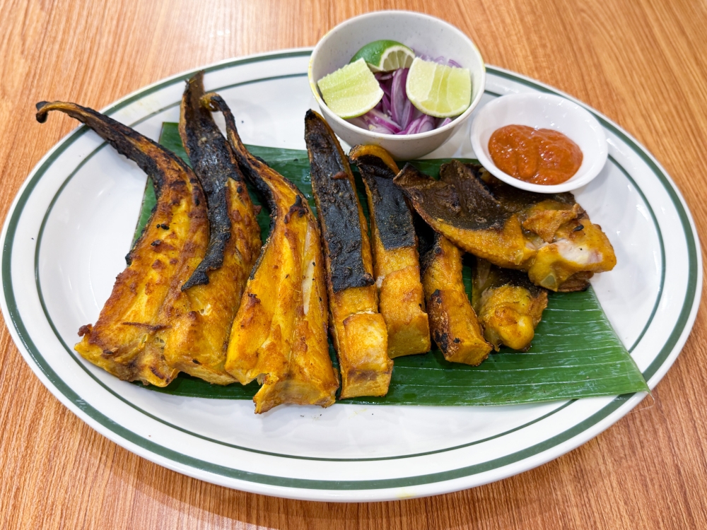 BBQ Stingray Fish gets the smoky makeover penetrating every piece so you can slowly relish it with their spicy sauce. — Picture by Lee Khang Yi
