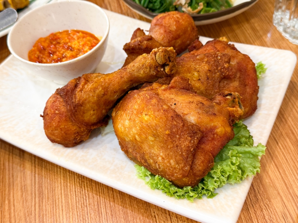 Ayam Goreng Kunyit Sambal Merah is the sleeper hit with juicy meat scented with turmeric powder and that mind blowing chilli sauce. — Picture by Lee Khang Yi