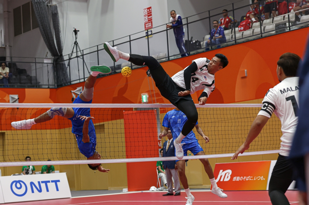 Malaysia’s Muhammad Afifuddin Mohd Razali attempts to block the ball from an Indian player during the men’s team regu sepak takraw event at the Aichi-Nagoya 2026 Asian Games in Nagoya on September 22, 2026; Malaysia won 3-0. — Bernama pic 