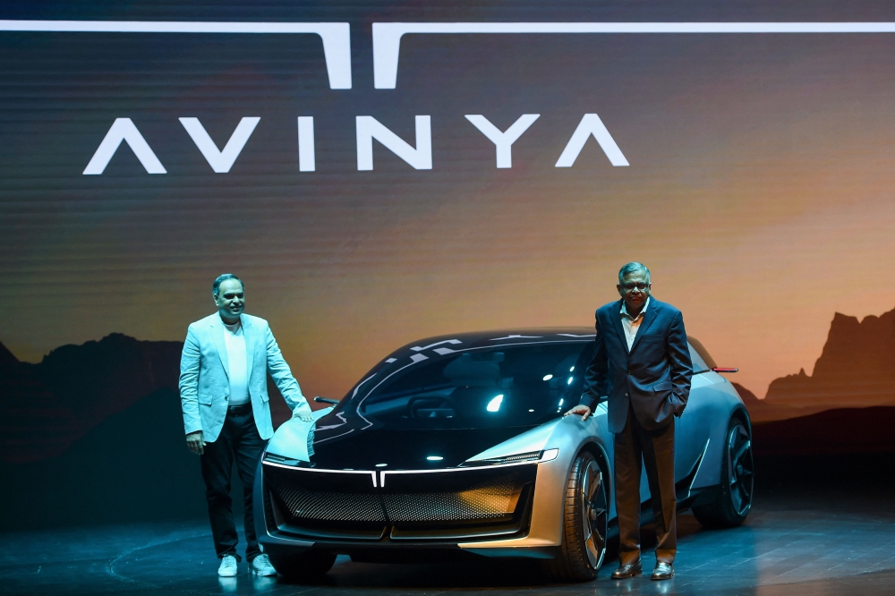 This file picture shows Tata Sons chairman Natarajan Chandrasekaran (right) and Tata Motors Passenger Vehicles and Tata Passenger Electric Mobility managing director Shailesh Chandra posing with the ‘Avinya’ concept car during its unveiling in Mumbai on April 29, 2022.