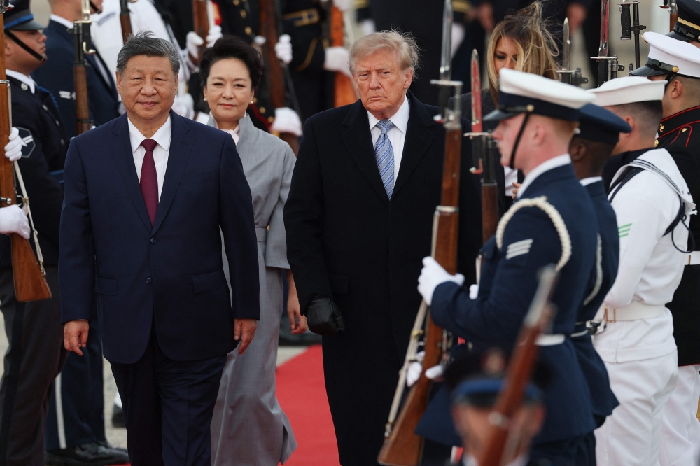 Chinese President Xi Jinping and First Lady Peng Liyuan walk with US President Donald Trump and First Lady Melania Trump during an arrival ceremony at Joint Base Andrews, Maryland, on September 23, 2026. — AFP pic