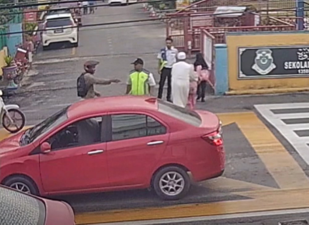 Police hunt motorcyclist after viral video shows two schoolgirls knocked down outside Bukit Mertajam school