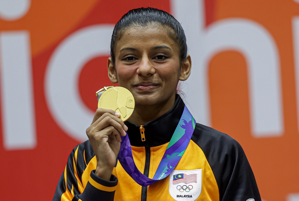 National karate exponent C. Shahmalarani shows off the gold medal she won in the women’s under-50kg kumite final at the Aichi-Nagoya 2026 Asian Games in Toyohashi on September 23, 2026. — Bernama pic