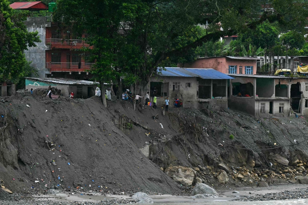 People wait to cross the Trishuli river via a zip line, in the aftermath of August 26 flash flood, at Devighat in Nepal's Nuwakot district on September 24, 2026. — AFP pic