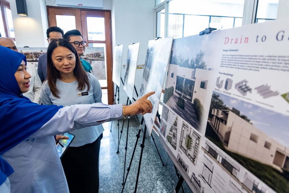 Federal Territories Minister Hannah Yeoh looks over proposed designs for Kuala Lumpur’s public toilets and shower facilities at the competition’s prize-giving ceremony on September 25, 2026. — Picture by Picture by Firdaus Latif