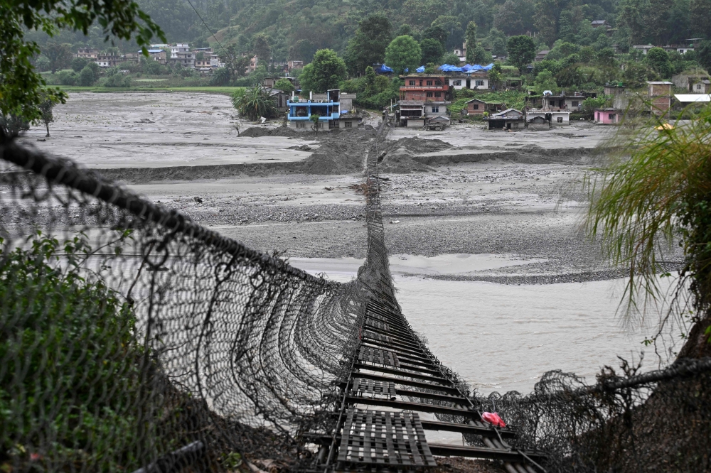 A general view of the damaged suspension bridge in the aftermath of the August 26 flash flood, at Taruka in Nepal’s Nuwakot district September 24, 2026. The tsunami-like flood that cut a swathe of destruction through Nepal on August 26 has left the Himalayan nation grappling with heavy losses and mounting reconstruction needs. — AFP pic