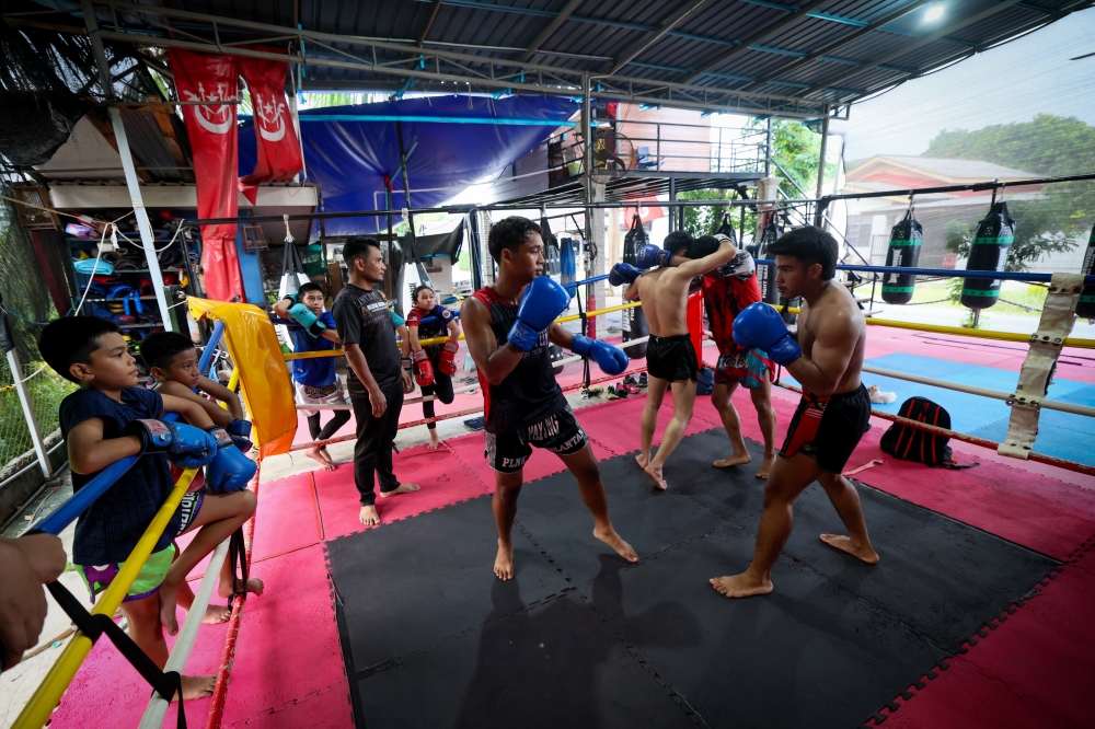 Muay Thai coach Mohamad Ridhwan Mat Zain (third left) watches athletes train at Sri Payung Muay Thai Club, Telipot, Kota Bharu. — Bernama pic
