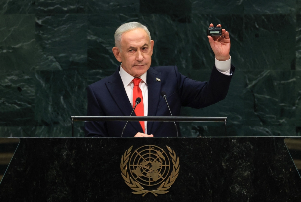 Israel’s Prime Minister Benjamin Netanyahu holds up a pager while addressing the 81st United Nations General Assembly in New York on September 24, 2026. — AFP pic