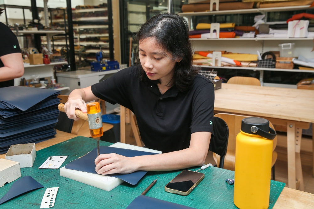 One of the artisans on Kelang Leather’s team is seen here working on a corporate gift. — Picture by Choo Choy May