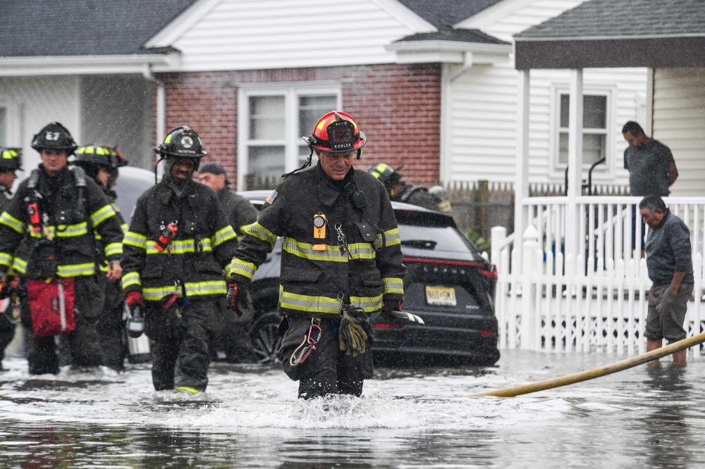 Firefighters of the Atlantic City Fire Department respond to a vehicle fire call in flood waters in Atlantic City, New Jersey, on September 26, 2026. — AFP pic