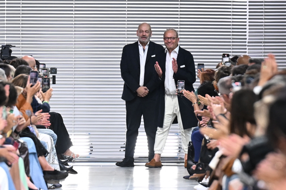 CEO Toni Scervino and designer Ermanno Daelli (right) greet the audience at the end of the Ermanno Scervino collection show as part of Women’s Spring/Summer 2027 Milan’s fashion week September 26, 2026. — AFP pic