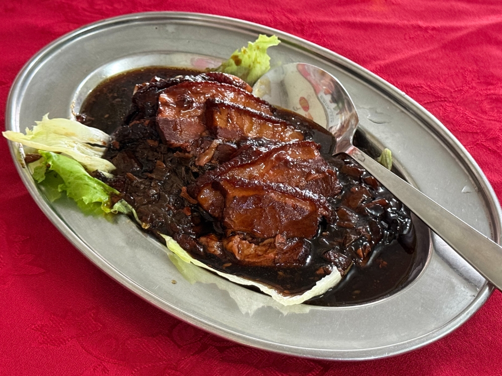 This version of Mui Choy Kaw Yoke will require multiple servings of rice as the pork belly and preserved mustard greens isn’t too salty and the fat is cooked to a luscious melt in the mouth texture. — Picture by Lee Khang Yi