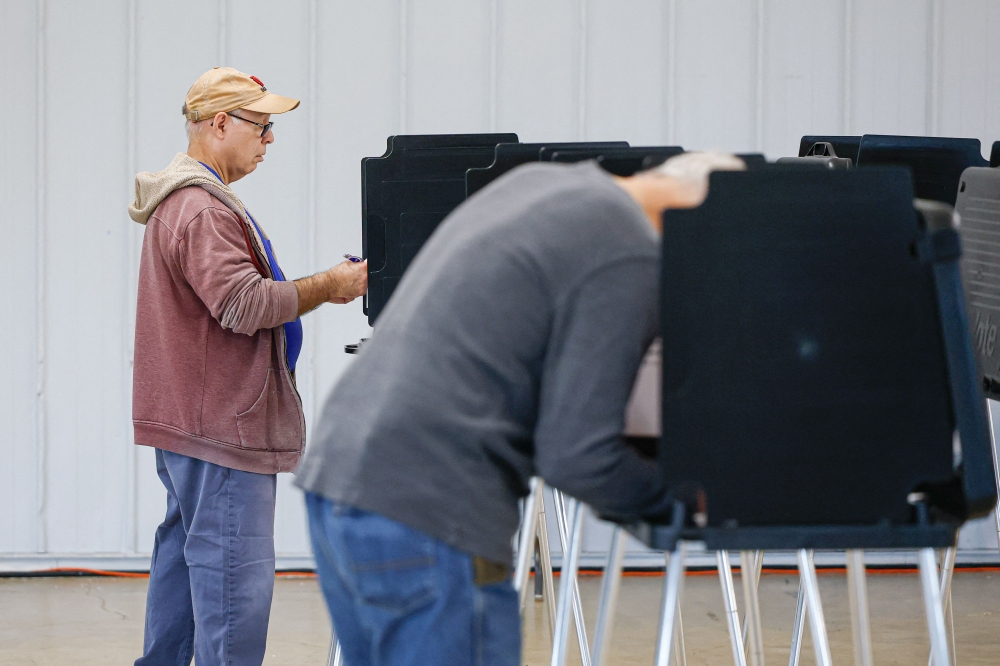 People vote on the second day of early voting ahead of the midterm elections, at a polling place at DuPage Event Center and Fairgrounds in Wheaton, Illinois, on September 25, 2026. NewsGuard said two pink slime networks — One Nation on the right, and the American Independent on the left — collectively spent at least US$801,500 on advertising in the first eight months of this year to promote their articles on Facebook and Instagram. — AFP pic